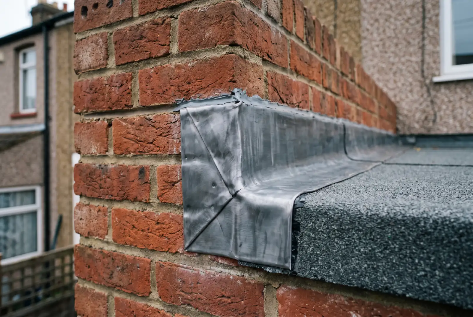 Flat roof upstand and wall flashing detail on Oxford extension